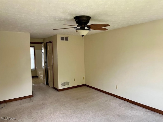 1023 55th St NE, Canton, OH 44721 - spare room with a ceiling fan, baseboards, light carpet, and a textured ceiling