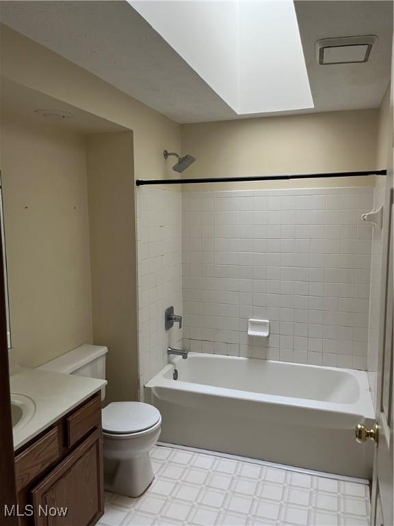 1023 55th St NE, Canton, OH 44721 - bathroom with vanity, toilet, tile patterned floors, and shower / tub combination