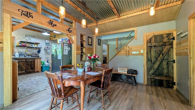 498 County Road 28, Steubenville, OH 43952 - dining area featuring a barn door and wood finished floors