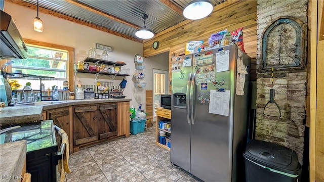 498 County Road 28, Steubenville, OH 43952 - kitchen with stainless steel refrigerator with ice dispenser, electric stove, hanging light fixtures, light countertops, and wooden walls