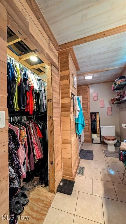 498 County Road 28, Steubenville, OH 43952 - bathroom with tile patterned floors, wood walls, toilet, and a spacious closet