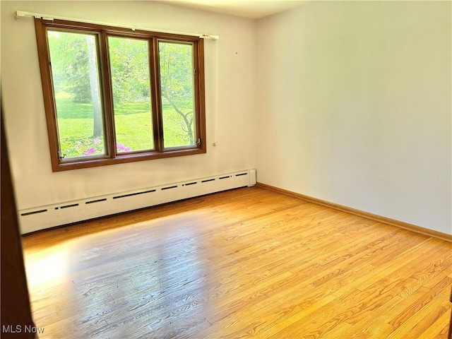 15959 Ridge Rd, North Royalton, OH 44133 - spare room featuring a baseboard radiator, light wood-type flooring, and baseboards