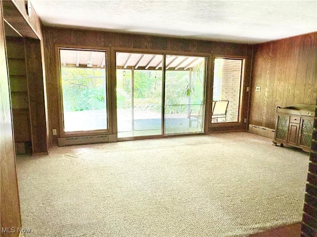 15959 Ridge Rd, North Royalton, OH 44133 - unfurnished living room with carpet flooring, wood walls, and a baseboard radiator