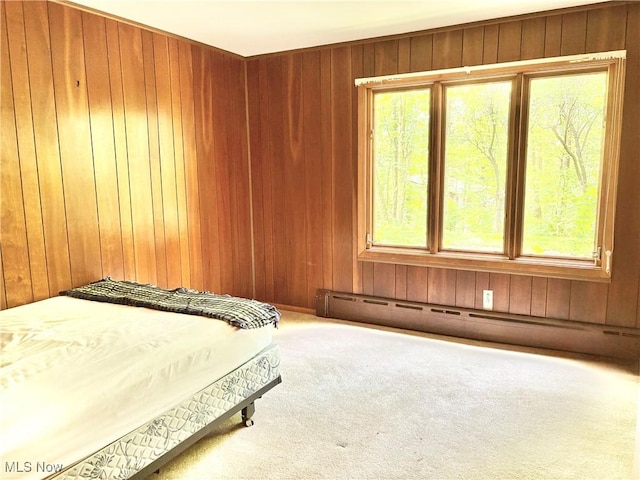 15959 Ridge Rd, North Royalton, OH 44133 - bedroom featuring multiple windows, carpet, wooden walls, and a baseboard radiator
