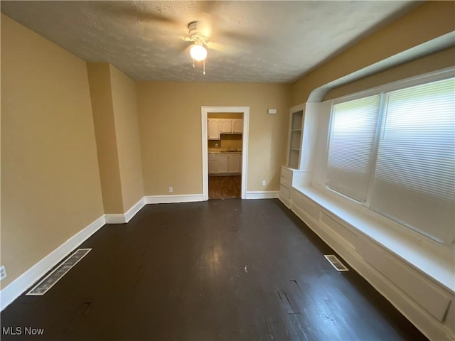 3454 E 118th St, Cleveland, OH 44120 - spare room with baseboards, dark wood finished floors, and a textured ceiling