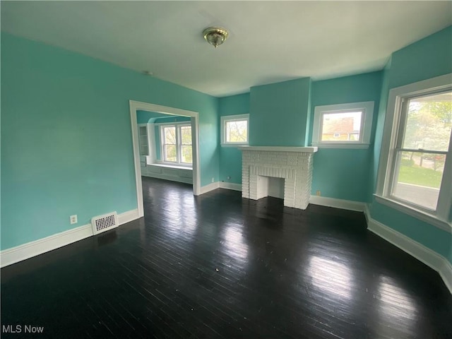 3454 E 118th St, Cleveland, OH 44120 - unfurnished living room with wood finished floors, healthy amount of natural light, and baseboards