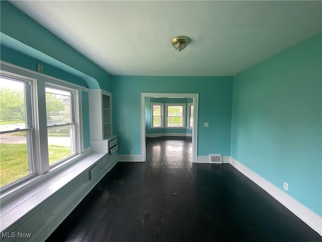 3454 E 118th St, Cleveland, OH 44120 - empty room featuring healthy amount of natural light, dark wood-style floors, and baseboards