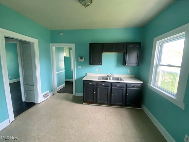 3454 E 118th St, Cleveland, OH 44120 - kitchen with a sink, baseboards, and light countertops
