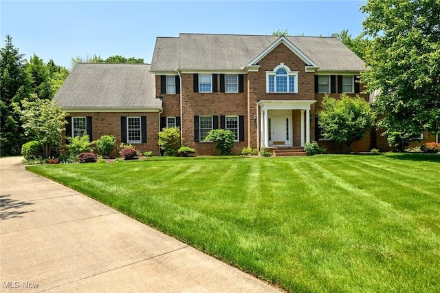 304 Fox Way, Chagrin Falls, OH 44022 - colonial inspired home featuring brick siding, a front yard, and roof with shingles