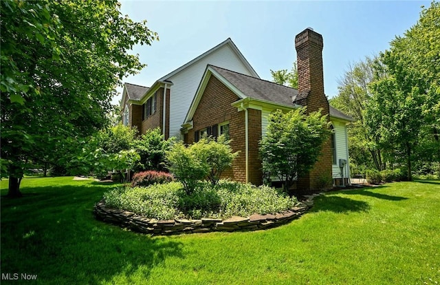 304 Fox Way, Chagrin Falls, OH 44022 - view of home's exterior featuring a chimney, brick siding, and a lawn