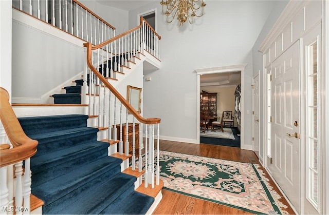 304 Fox Way, Chagrin Falls, OH 44022 - entrance foyer with stairs, a chandelier, wood finished floors, baseboards, and a towering ceiling