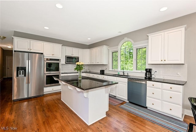 304 Fox Way, Chagrin Falls, OH 44022 - kitchen featuring stainless steel appliances, white cabinets, a kitchen island, tasteful backsplash, and recessed lighting