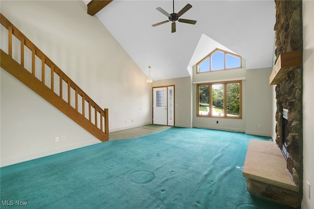 1908 Players Cir, Uniontown, OH 44685 - unfurnished living room with high vaulted ceiling, carpet floors, a fireplace, ceiling fan, and stairs