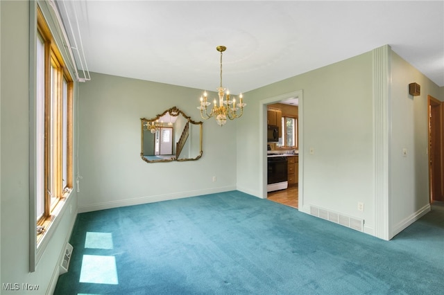 1908 Players Cir, Uniontown, OH 44685 - carpeted spare room featuring a chandelier and baseboards
