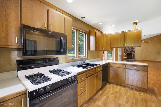 1908 Players Cir, Uniontown, OH 44685 - kitchen featuring black appliances, a sink, light wood-type flooring, light countertops, and brown cabinets