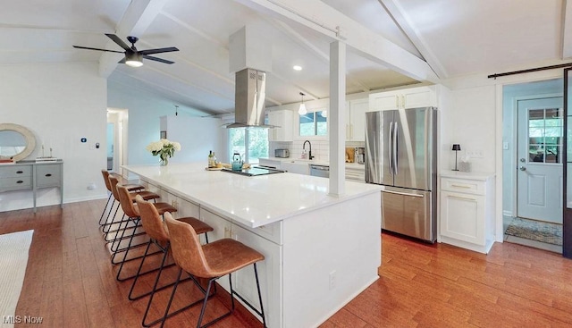 932 Bell Rd, Chagrin Falls, OH 44022 - kitchen featuring appliances with stainless steel finishes, wood finished floors, white cabinetry, and a kitchen breakfast bar