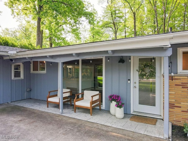 932 Bell Rd, Chagrin Falls, OH 44022 - doorway to property with board and batten siding and a patio