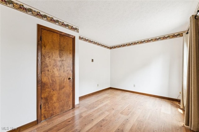 43628 Crestview Rd, Columbiana, OH 44408 - spare room with light wood-style flooring, a textured ceiling, and baseboards