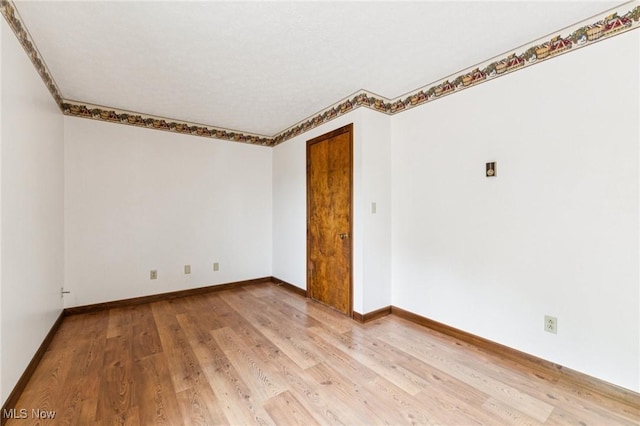 43628 Crestview Rd, Columbiana, OH 44408 - empty room featuring light wood-type flooring, baseboards, and ornamental molding