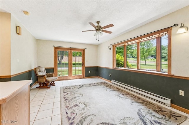 43628 Crestview Rd, Columbiana, OH 44408 - unfurnished room with a baseboard heating unit, a ceiling fan, light tile patterned floors, a textured ceiling, and baseboards