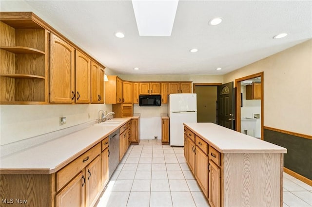 43628 Crestview Rd, Columbiana, OH 44408 - kitchen featuring black microwave, freestanding refrigerator, a sink, a center island, and light tile patterned flooring
