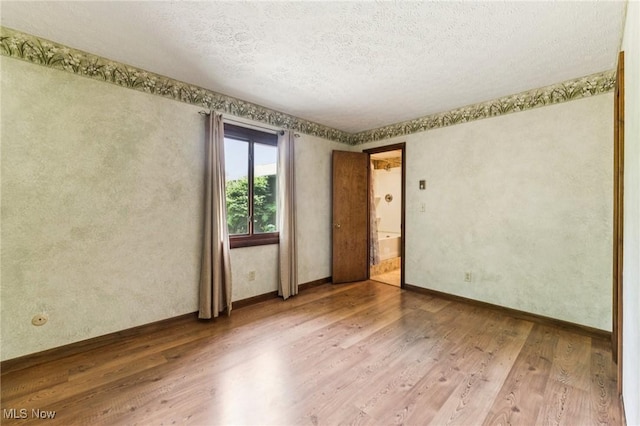 43628 Crestview Rd, Columbiana, OH 44408 - unfurnished room with wood finished floors, a textured ceiling, and baseboards