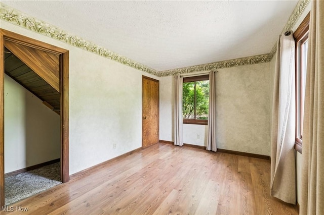 43628 Crestview Rd, Columbiana, OH 44408 - unfurnished room featuring light wood-style flooring, baseboards, and a textured ceiling