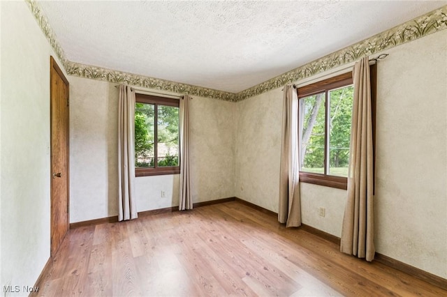 43628 Crestview Rd, Columbiana, OH 44408 - unfurnished room featuring light wood-style floors, a textured ceiling, and baseboards