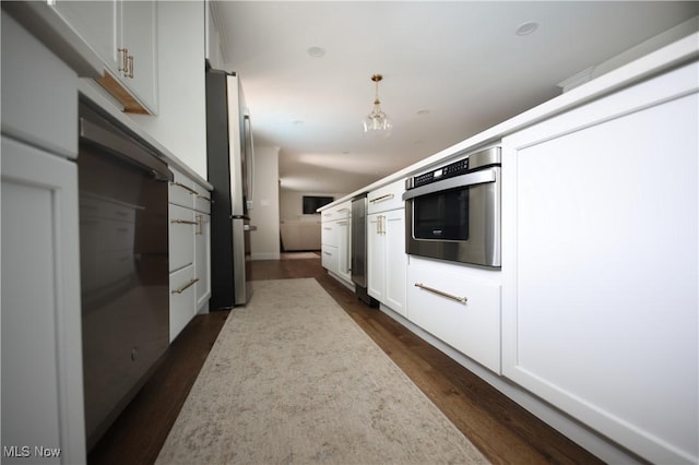 327 Country Club Blvd, Weirton, WV 26062 - kitchen featuring appliances with stainless steel finishes, dark wood-style flooring, pendant lighting, light countertops, and white cabinets
