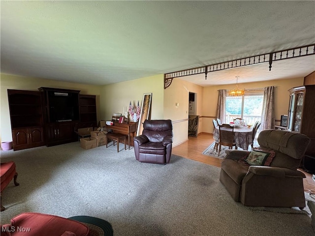 9 James Ct, Parkersburg, WV 26105 - carpeted living room featuring a chandelier and a textured ceiling