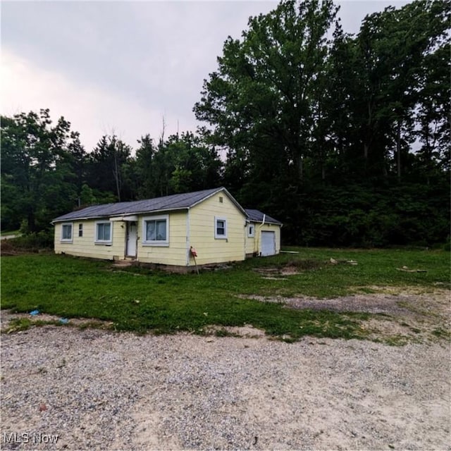 6303 E US-35, West Alexandria, OH 45320 - view of property exterior with a lawn and metal roof