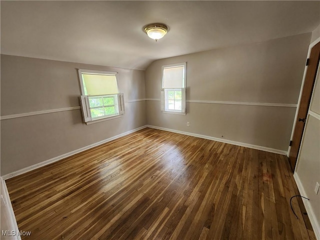 1039 Argonne Rd, South Euclid, OH 44121 - spare room featuring dark wood-type flooring, lofted ceiling, and baseboards