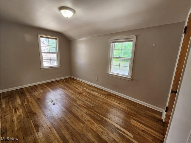 1039 Argonne Rd, South Euclid, OH 44121 - empty room with dark wood-type flooring, plenty of natural light, baseboards, and lofted ceiling