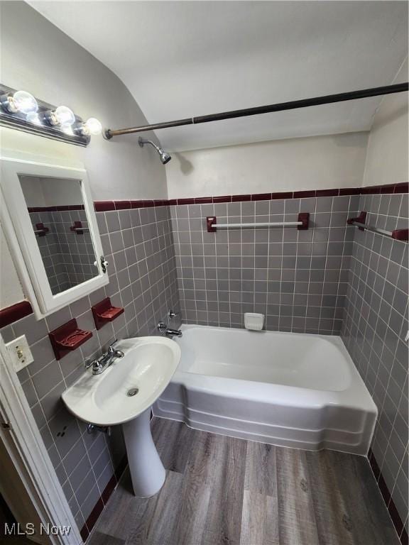 1039 Argonne Rd, South Euclid, OH 44121 - full bathroom featuring tile walls, wood finished floors, shower / bath combination, and a sink