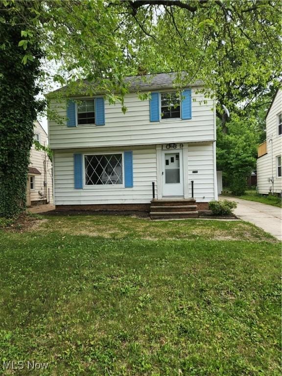 1039 Argonne Rd, South Euclid, OH 44121 - colonial-style house featuring a front lawn, entry steps, and driveway