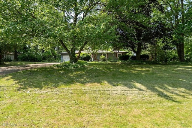 18373 Bentwood Dr, Doylestown, OH 44230 - view of green lawn featuring a garage and driveway
