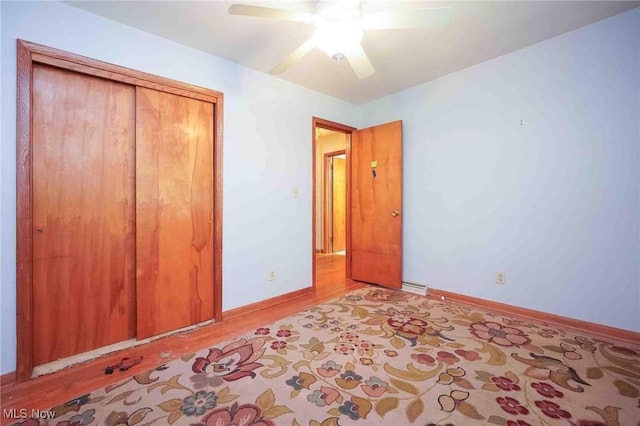 18373 Bentwood Dr, Doylestown, OH 44230 - unfurnished bedroom with light wood-style flooring, a ceiling fan, a closet, baseboards, and baseboard heating