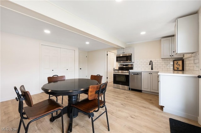 472 Saunders Ave, Coventry, OH 44319 - dining space featuring light wood finished floors, recessed lighting, and beamed ceiling