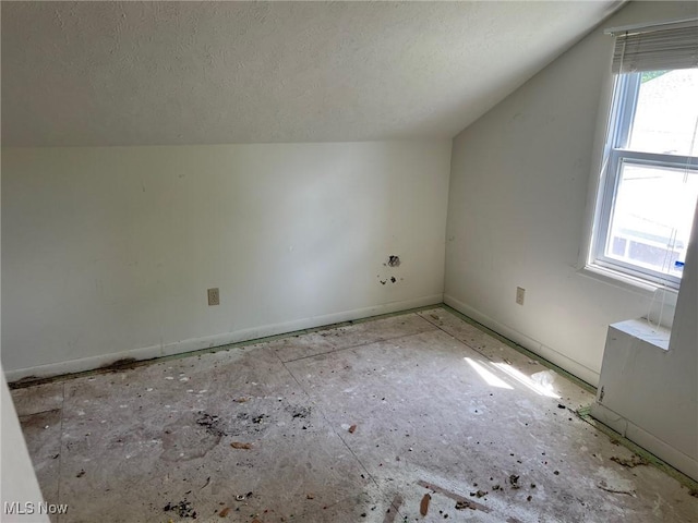 27182 Oriole Ave, Euclid, OH 44132 - additional living space with lofted ceiling, a textured ceiling, and baseboards