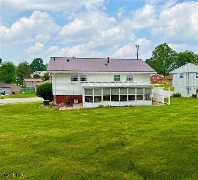 904 Donegal Dr W, Follansbee, WV 26037 - rear view of house featuring a yard, a sunroom, and metal roof