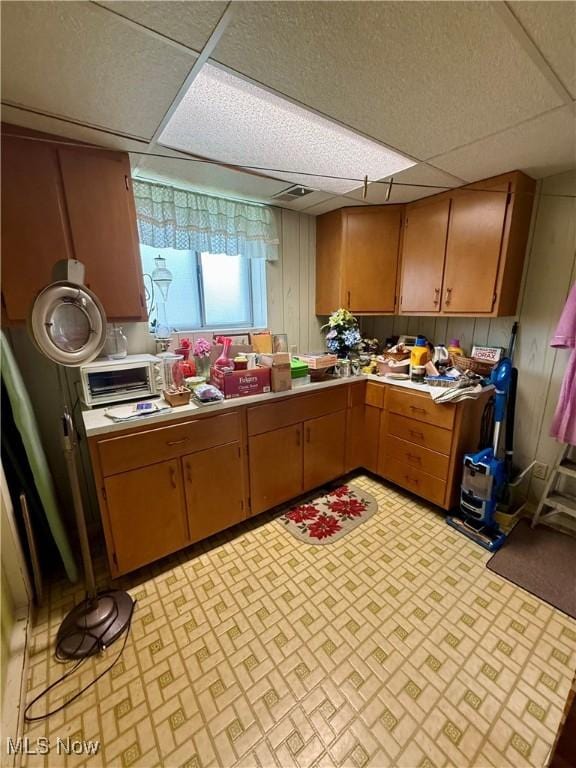 904 Donegal Dr W, Follansbee, WV 26037 - kitchen featuring a paneled ceiling, light countertops, and brown cabinetry