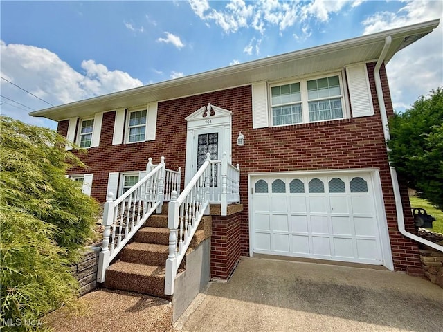 904 Donegal Dr W, Follansbee, WV 26037 - split foyer home featuring driveway, brick siding, and an attached garage