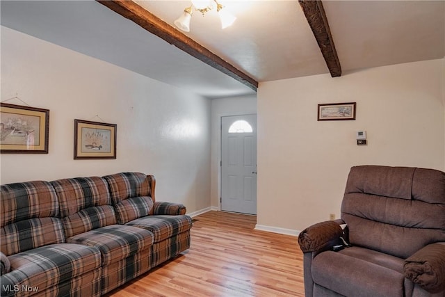 1303 28th St, Vienna, WV 26105 - living room featuring beamed ceiling, light wood-type flooring, and baseboards