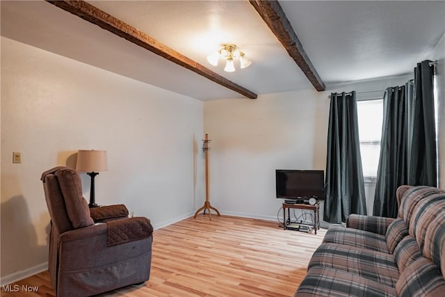 1303 28th St, Vienna, WV 26105 - living area featuring beamed ceiling, light wood finished floors, and baseboards