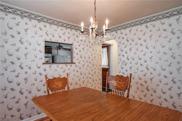1303 28th St, Vienna, WV 26105 - dining room featuring arched walkways, a chandelier, and wallpapered walls