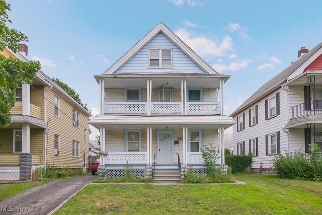 4101 E 64th St, Cleveland, OH 44105 - view of front of property featuring covered porch, a front yard, and a balcony
