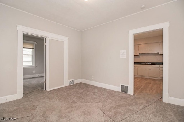 4101 E 64th St, Cleveland, OH 44105 - empty room with carpet flooring, baseboards, and a sink