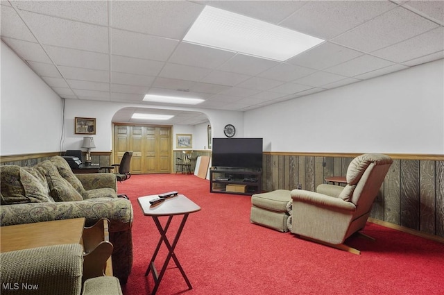 962 N Market St, Lisbon, OH 44432 - living room featuring carpet flooring, arched walkways, wainscoting, a paneled ceiling, and wood walls