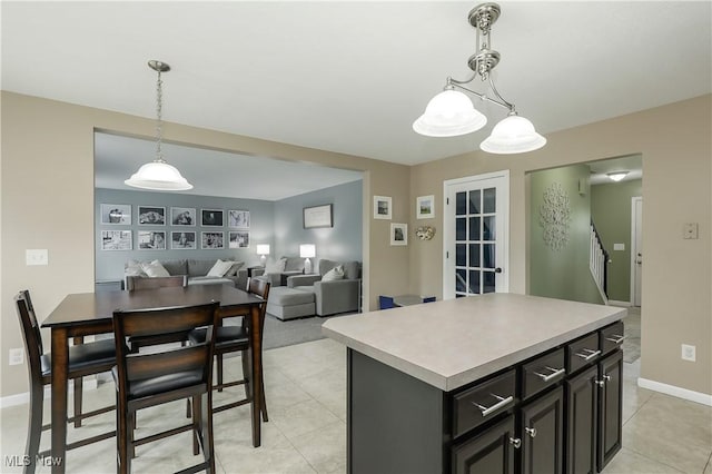 189 Booth Bay Dr, Medina, OH 44256 - kitchen with light tile patterned floors, a center island, light countertops, and hanging light fixtures