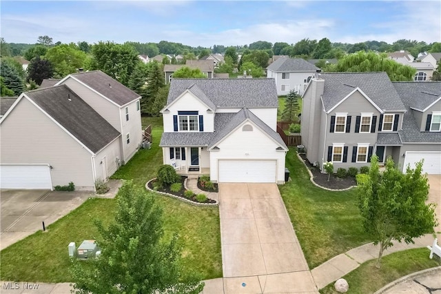 189 Booth Bay Dr, Medina, OH 44256 - view of front facade featuring roof with shingles, driveway, a residential view, and a front lawn